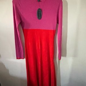 Asymmetric, pink and orange knit long sleeve dress. Hugs the figure.